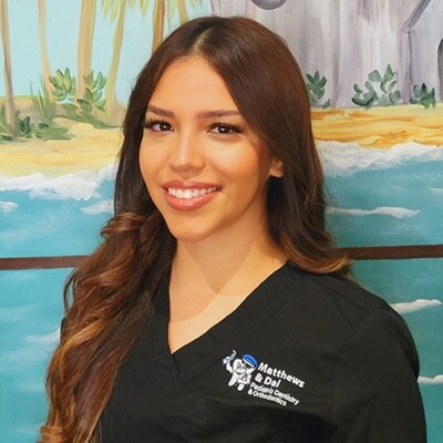 Bianca, dental team member at Spring, TX practice, smiling in professional black scrubs.