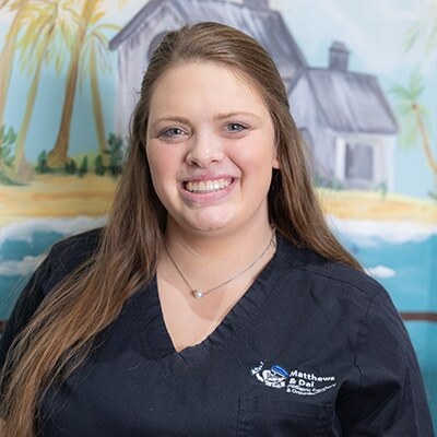 Smiling dental team member in black scrubs at Spring, TX dental practice.