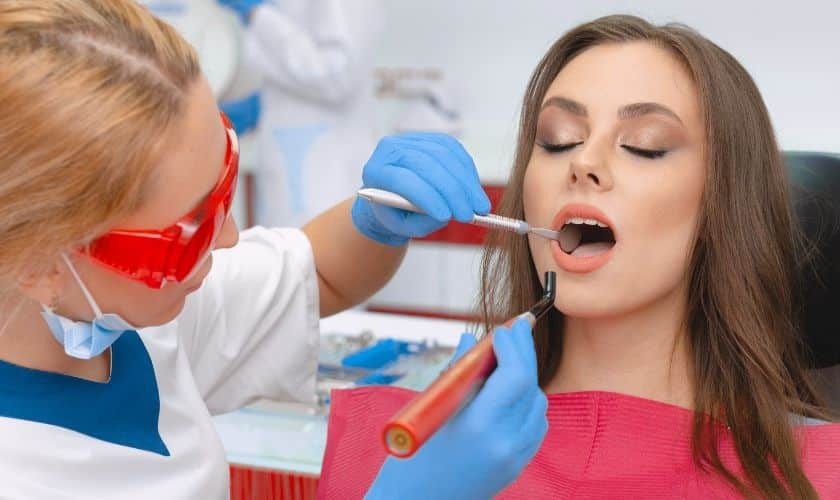 Dentist examining patient's teeth during restorative dental treatment in Spring, TX.