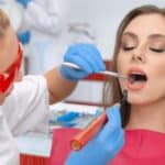 Dentist examining patient's teeth during restorative dental treatment in Spring, TX.