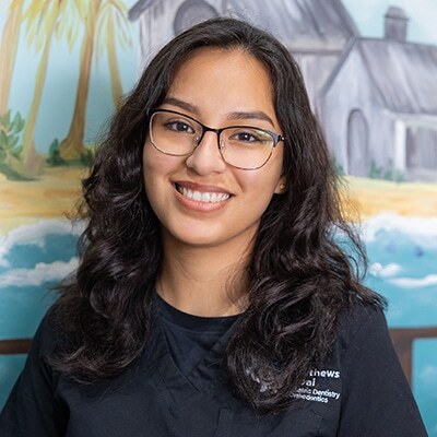 Jen, dental team member at Spring, TX practice, smiling at camera.