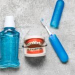 Mouthwash, toothbrush, and orthodontic model with braces for fresh breath care.