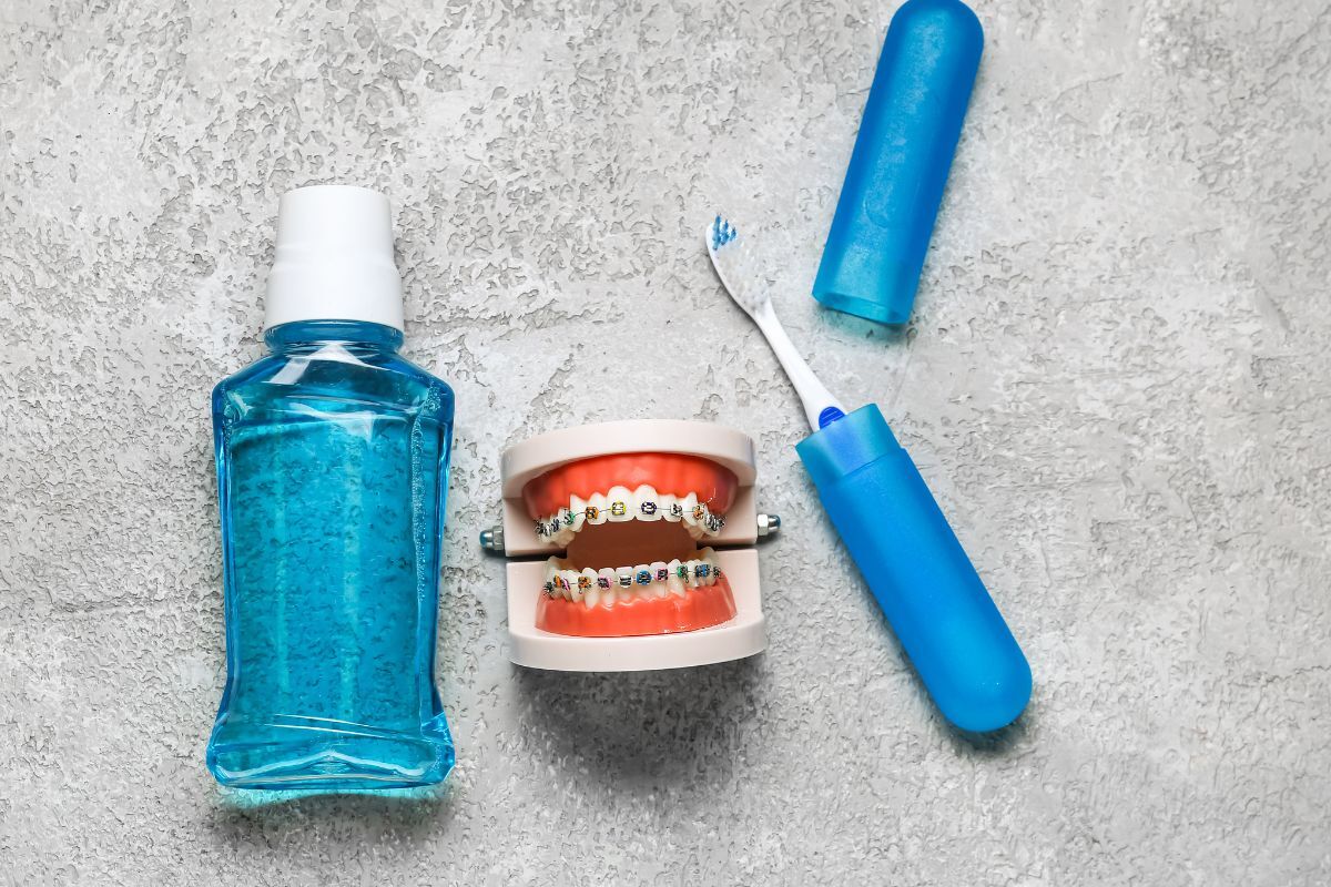 Mouthwash, toothbrush, and orthodontic model with braces for fresh breath care.