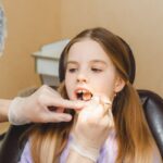 Young patient receiving dental examination in Spring, TX dental office.