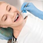 Pediatric patient receiving dental examination with orthodontic tools in Spring, TX.