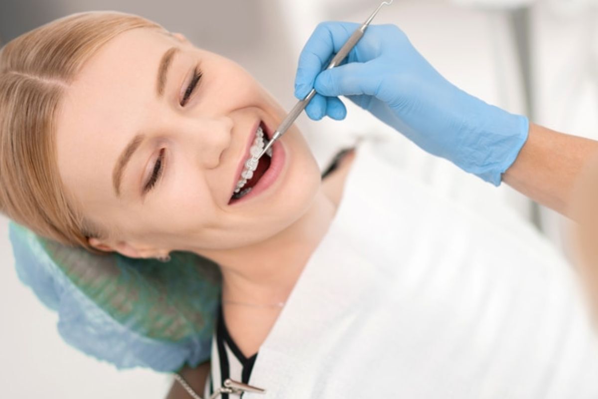 Pediatric patient receiving dental examination with orthodontic tools in Spring, TX.